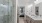 Luxury bathroom at The Portier Midtown Apartments featuring a glass-enclosed walk-in shower with marble inspired tile, dual quartz vanities, modern fixtures, and bright lighting for a spa-inspired feel.