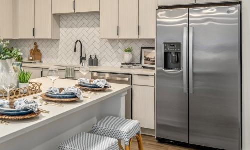 Stainless steel GE appliance suite in a Portier Midtown kitchen