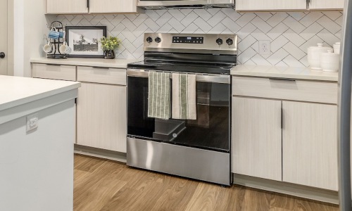 Stainless steel GE appliance suite in a Portier Midtown kitchen