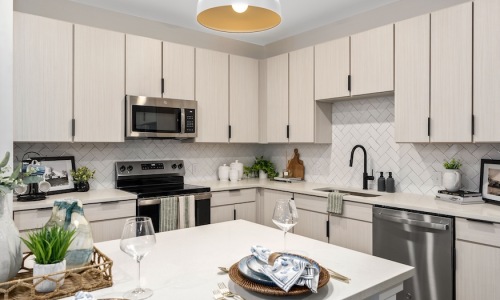 Polished white quartz countertops (Heron Stone Simply White) at The Portier Midtown