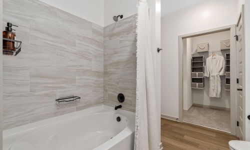 Calacatta marble-look porcelain shower tile (Daltile Calacatta Sky CT75) at The Portier Midtown