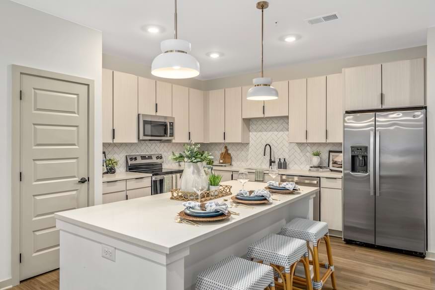 Warm wood-grain Saco Seria kitchen cabinetry at The Portier Midtown