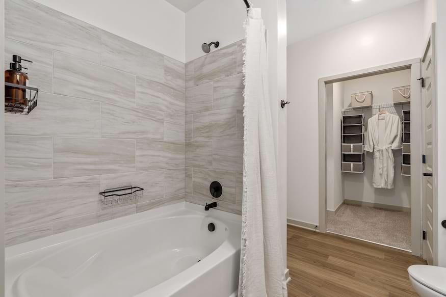 Calacatta marble-look porcelain shower tile (Daltile Calacatta Sky CT75) at The Portier Midtown