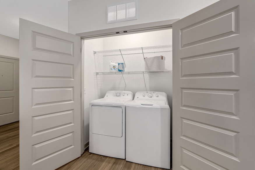 washer and dryer in a bright closet area